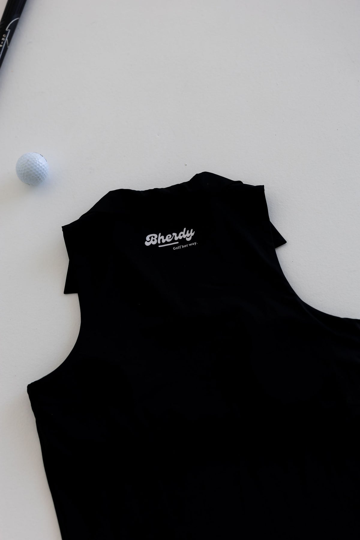 Women's form-fitted golf tank collar detail — Bherdy Performance Collared Tank