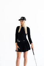 Women wearing black trucker hat and golf outfit — Bherdy Golf